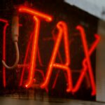 Neon sign that says "TAX"
