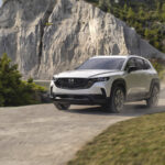2026 Mazda CX-50 Hybrid driving on dusty road