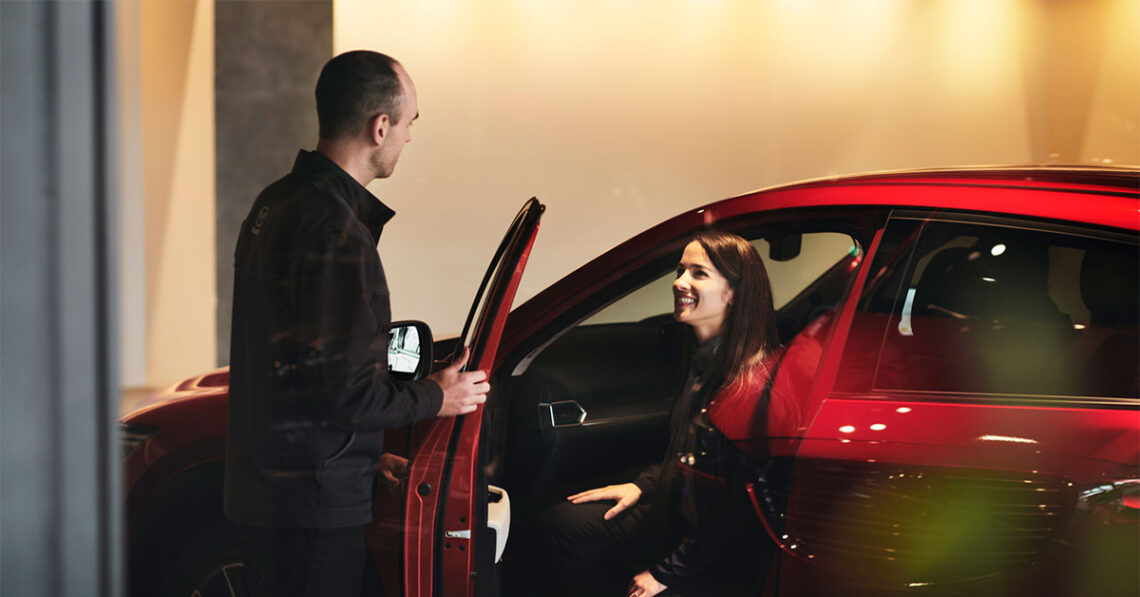 Customer in Mazda car with dealer