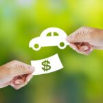 Hand with paper money and car shape. new car buy concept