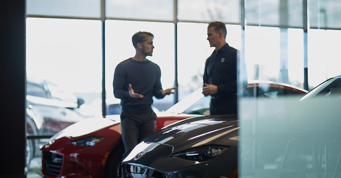 Customer and dealer in the Mazda showroom