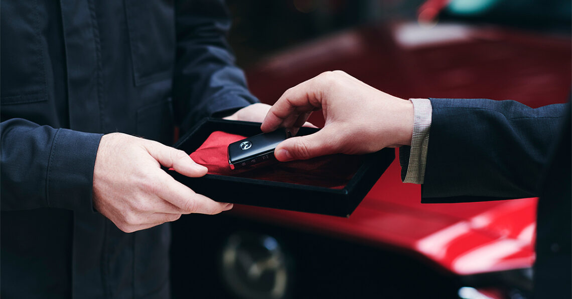 Key exchange in front of Mazda vehicle