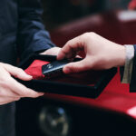 Key exchange in front of Mazda vehicle